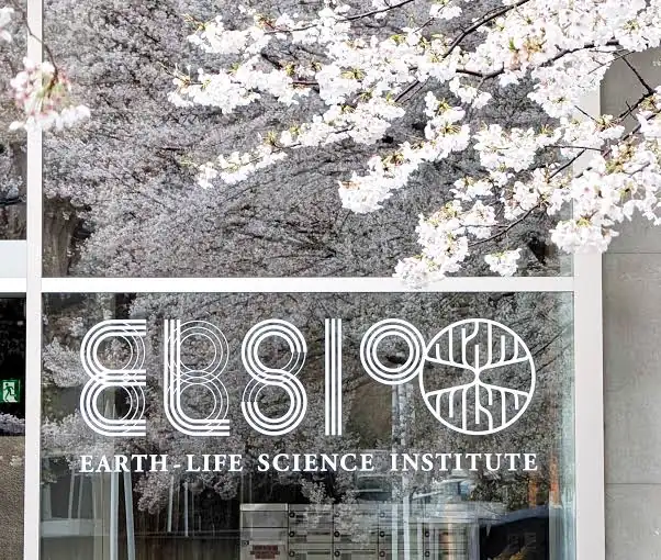 Glass entrance with the Earth-Life Science Institute logo and name, framed by pale cherry blossoms
